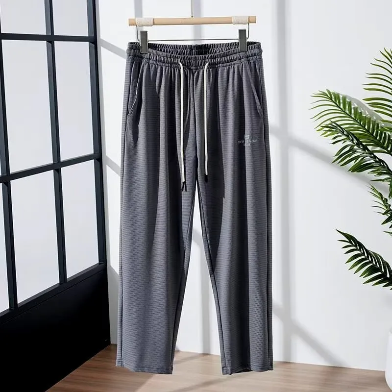 Men's thin grey ice silk casual trousers with a loose straight-leg fit and ankle-tied detail.