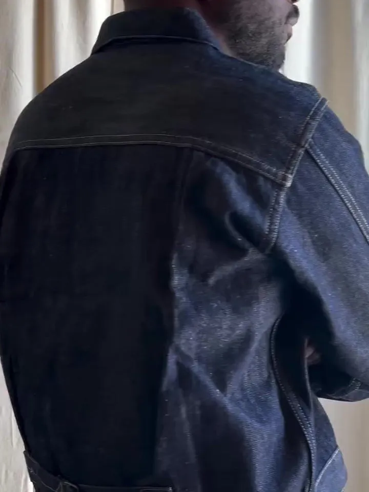 Dark blue denim button-up jacket with classic collar on a standard hanger