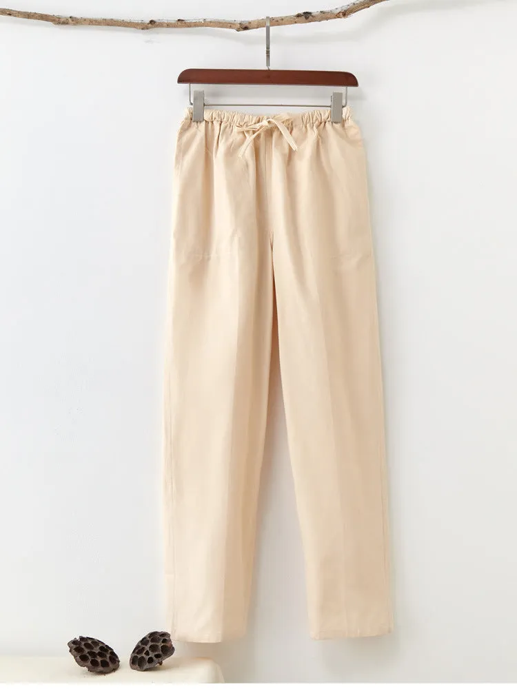 Men's beige pure cotton casual trousers with drawstring waist and belt on a neutral background.