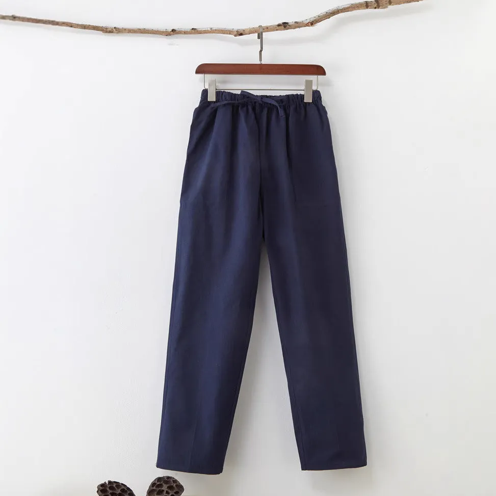 Men's beige pure cotton casual trousers with drawstring waist and belt on a neutral background.