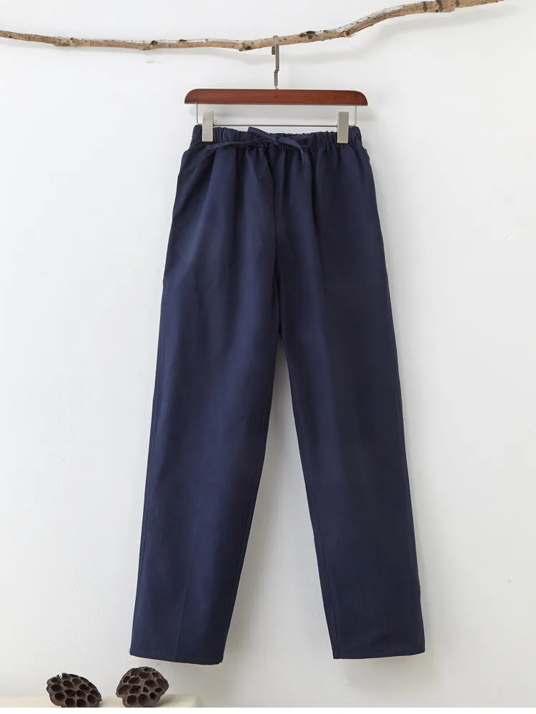 Men's beige pure cotton casual trousers with drawstring waist and belt on a neutral background.