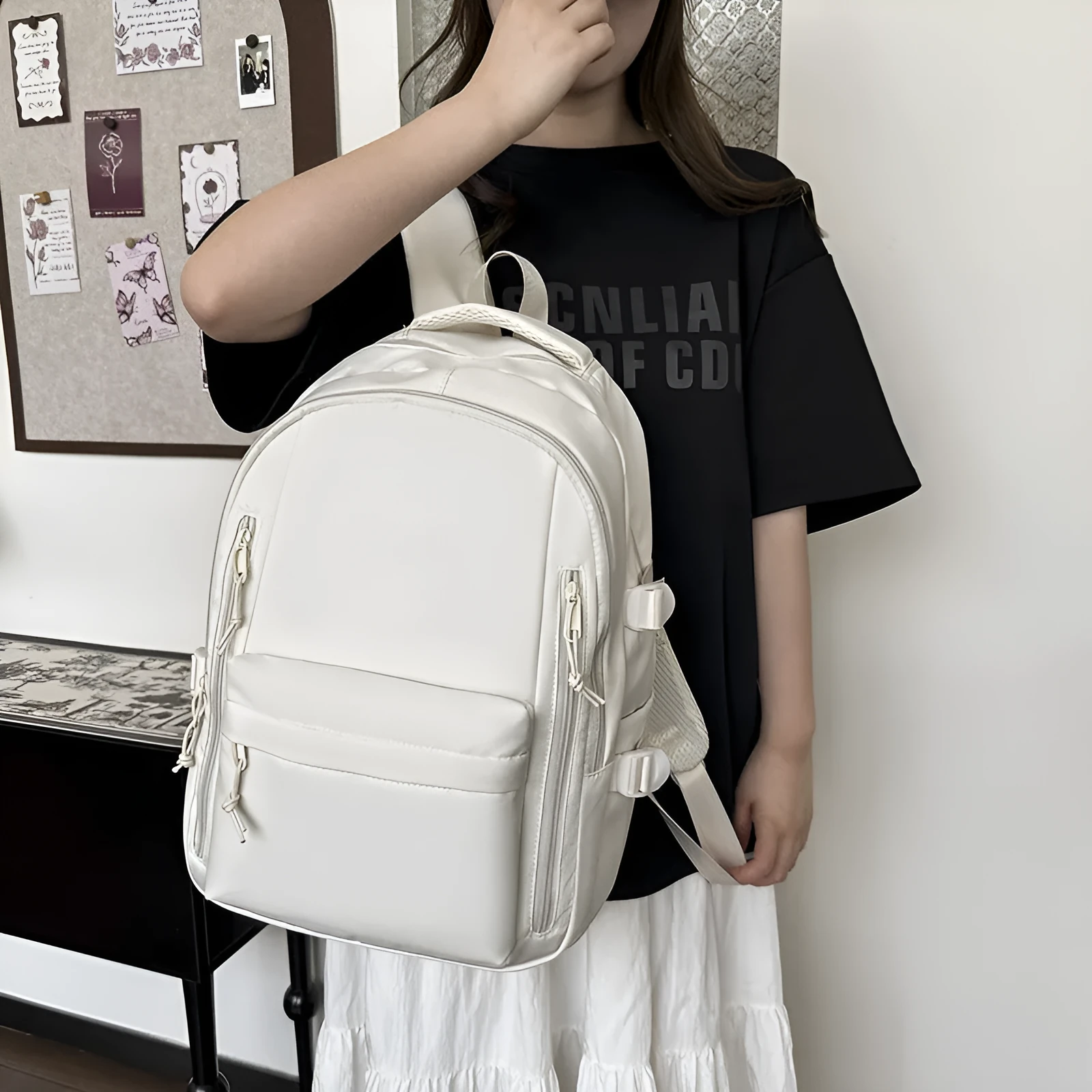Women's large capacity solid colour schoolbag in black with curved shoulder strap and nylon material