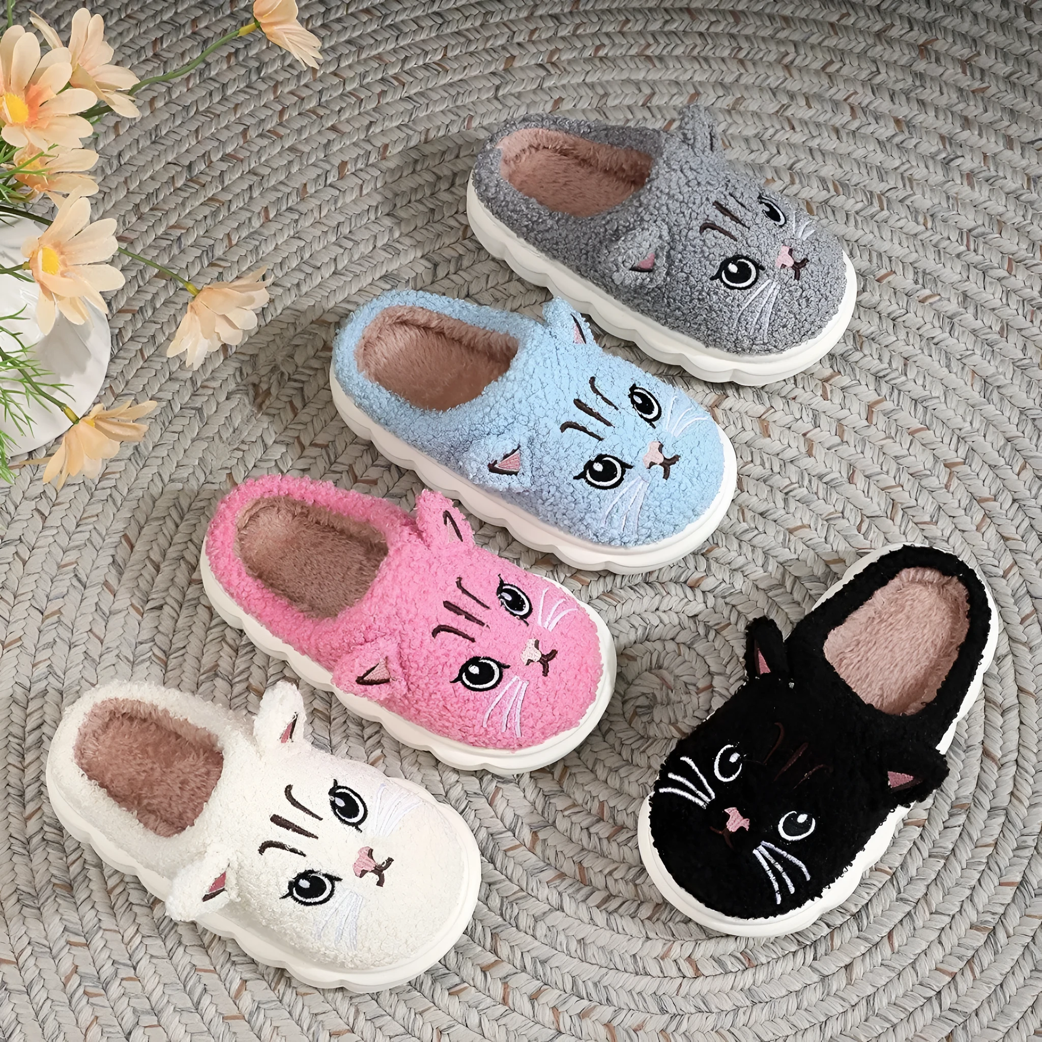 Pair of pink winter cartoon cat fluffy slippers on floor, non-slip EVA sole