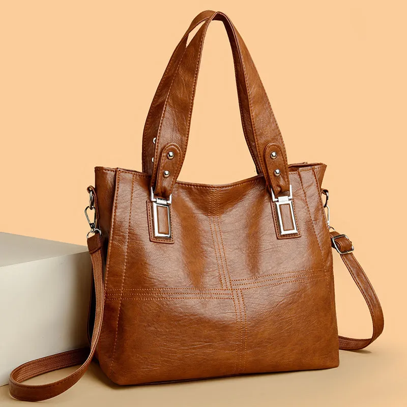 Women's soft PU handbag in horizontal square shape with sewing thread detail and single shoulder strap.