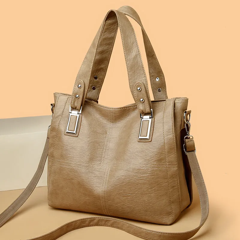 Women's soft PU handbag in horizontal square shape with sewing thread detail and single shoulder strap.