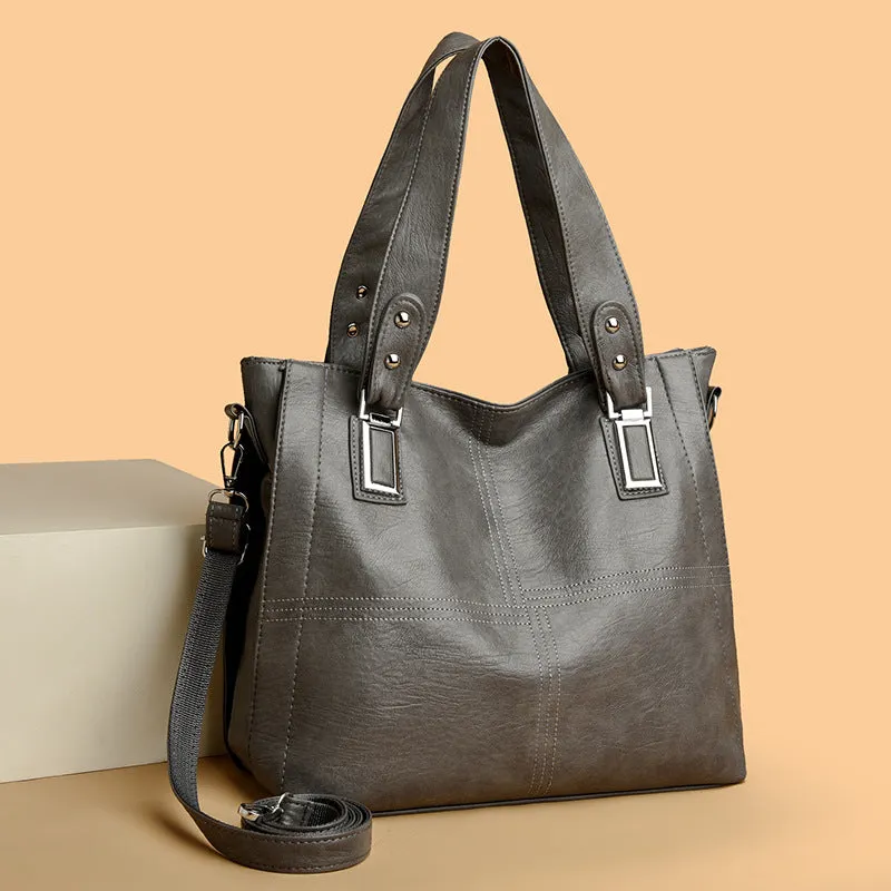 Women's soft PU handbag in horizontal square shape with sewing thread detail and single shoulder strap.