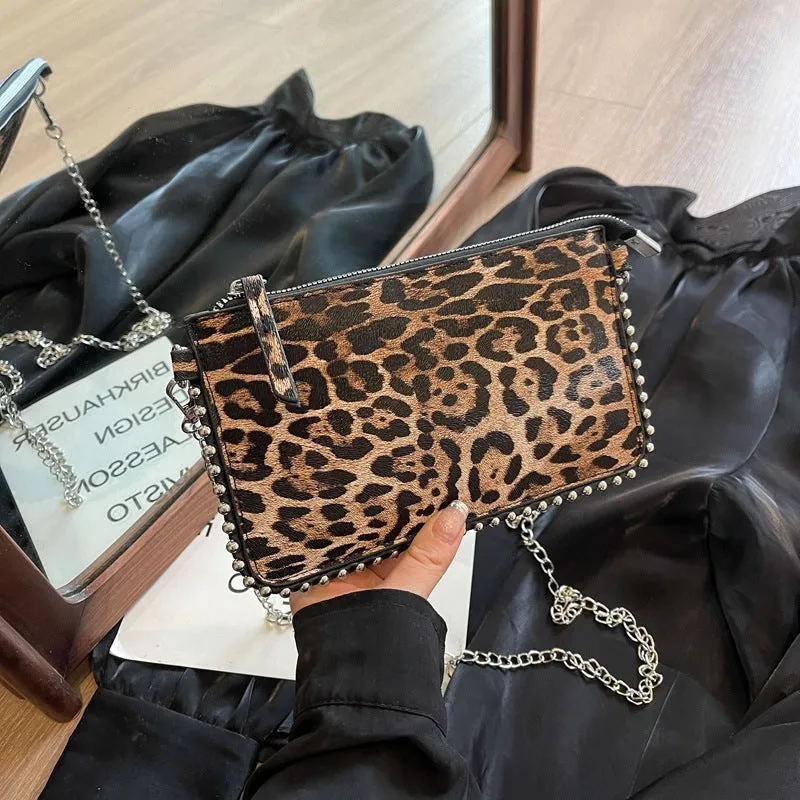 Women's square crossbody bag in PU leather with chain detail, shown in dark brown colour