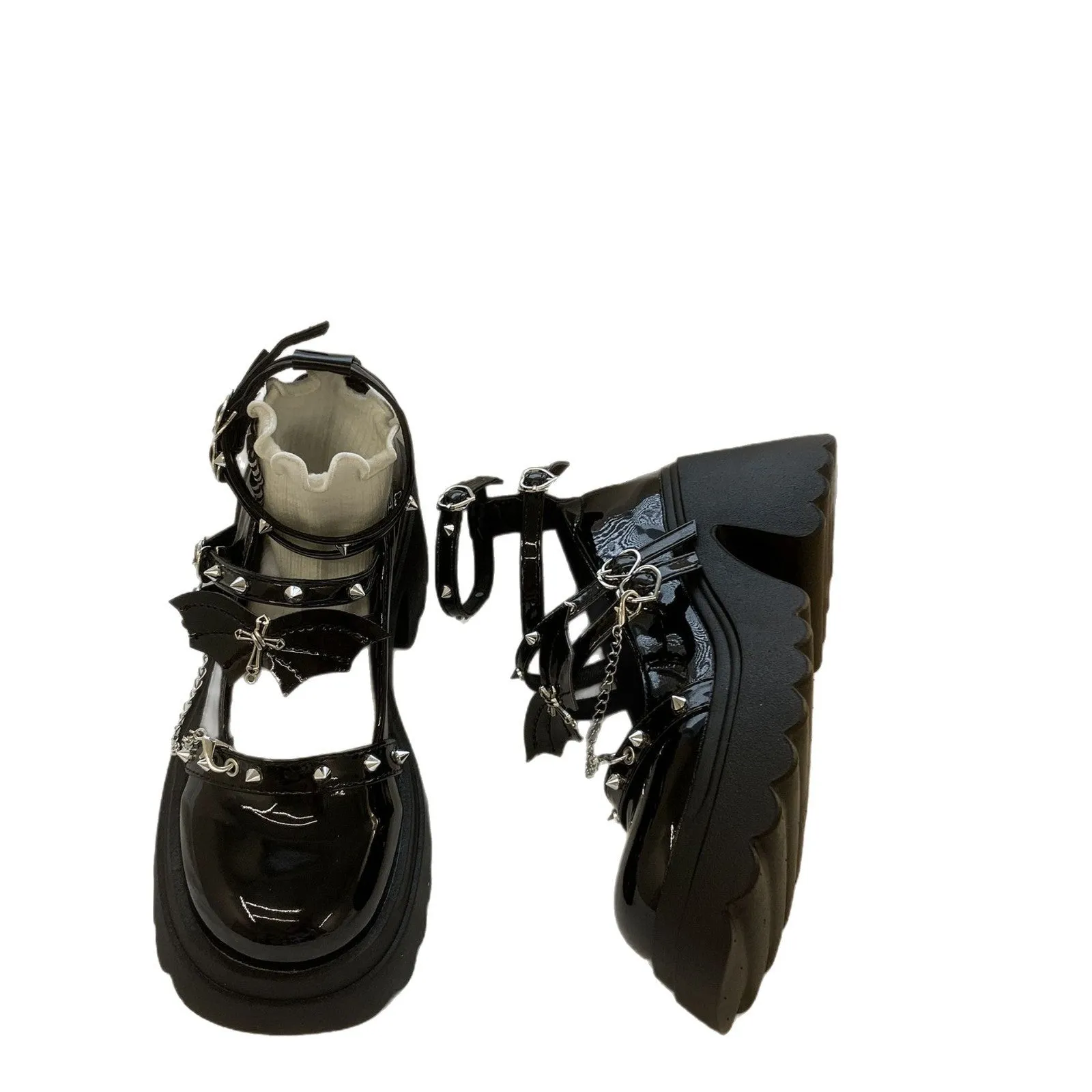 Black patent leather bat cosplay Lolita shoes with metal chain buckle and chunky heel on white background
