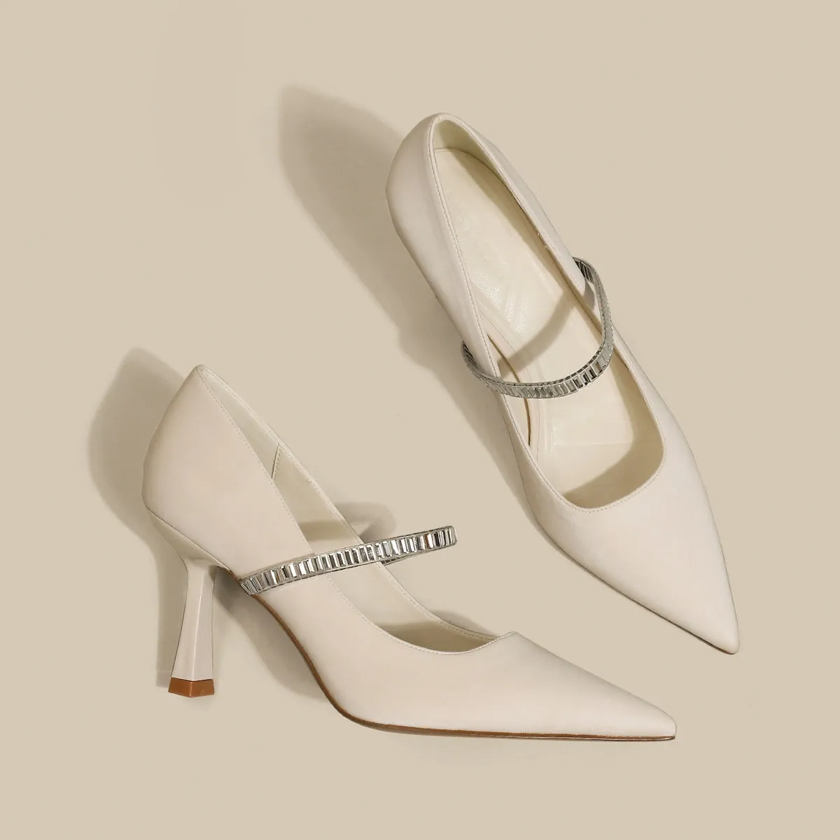 Women's black stiletto heel sandals with a closed toe and a silver buckle strap across the instep.