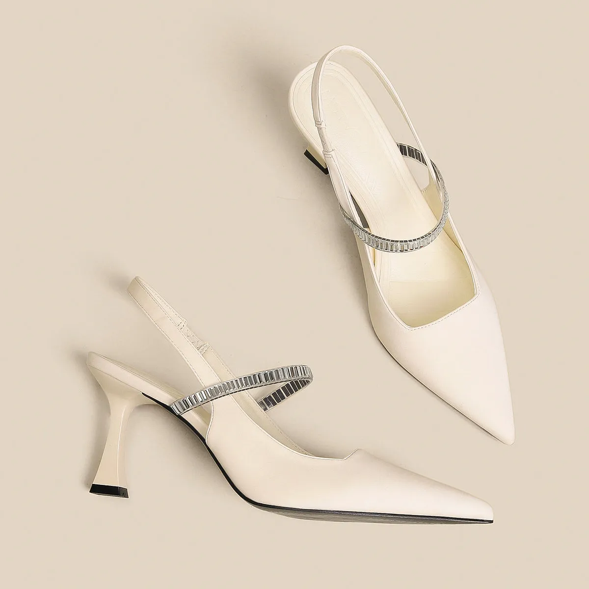 Women's black stiletto heel sandals with a closed toe and a silver buckle strap across the instep.