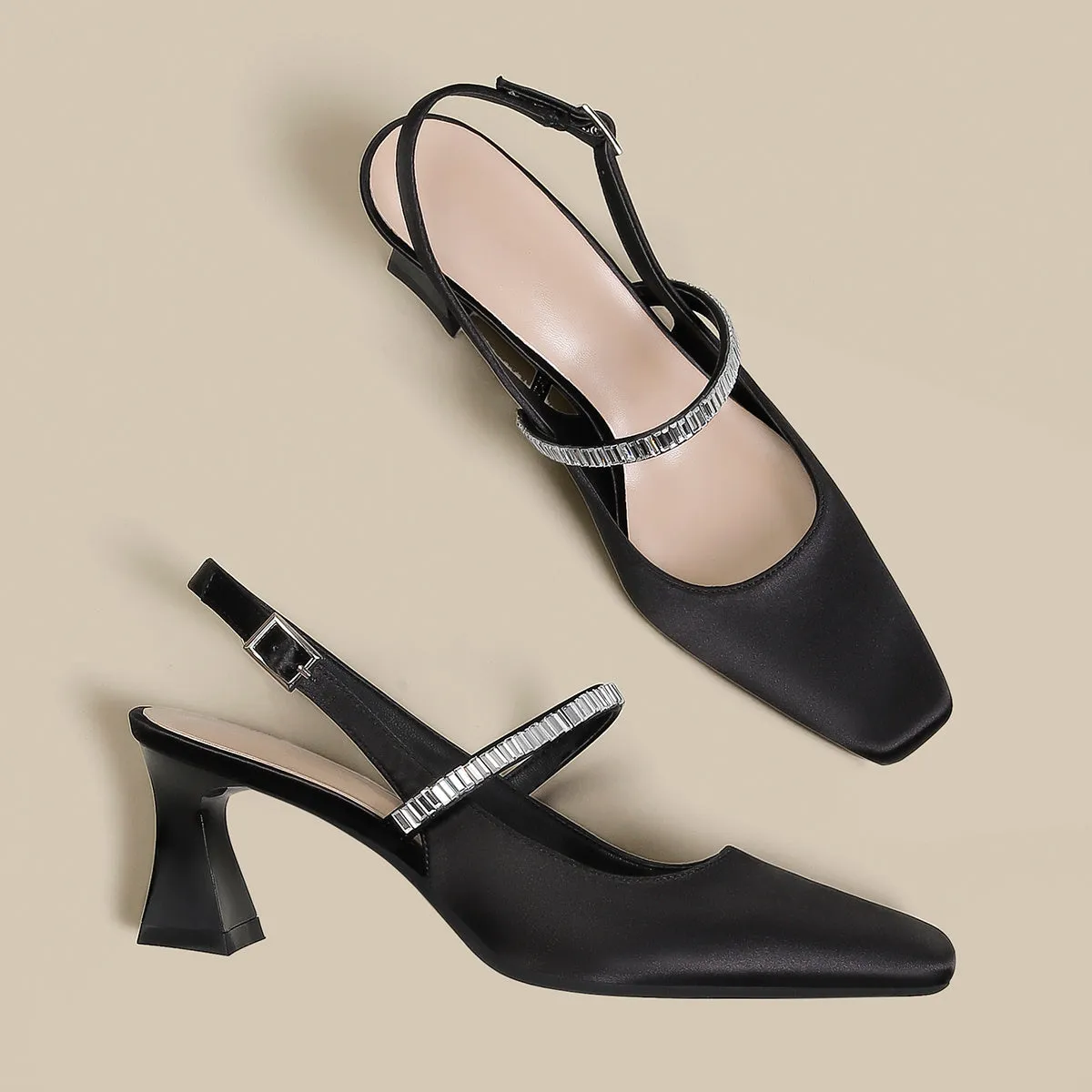 Women's black stiletto heel sandals with a closed toe and a silver buckle strap across the instep.