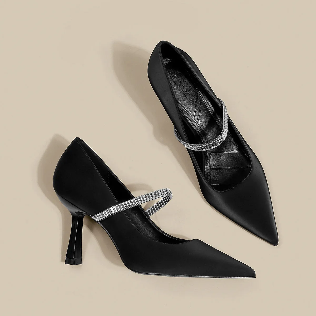 Women's black stiletto heel sandals with a closed toe and a silver buckle strap across the instep.