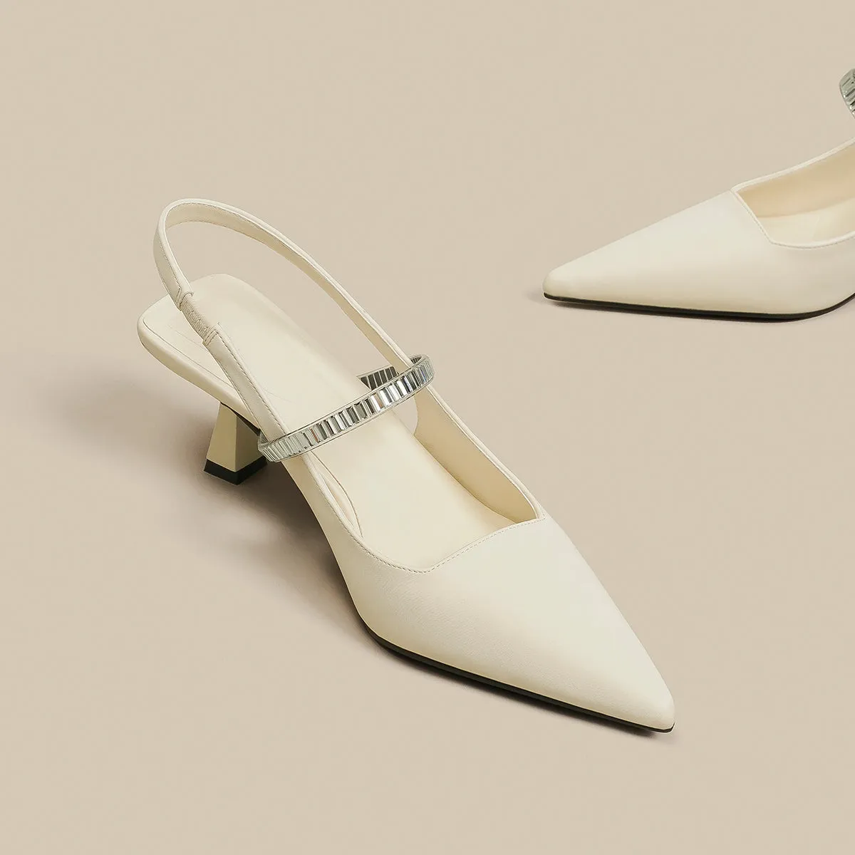 Women's black stiletto heel sandals with a closed toe and a silver buckle strap across the instep.