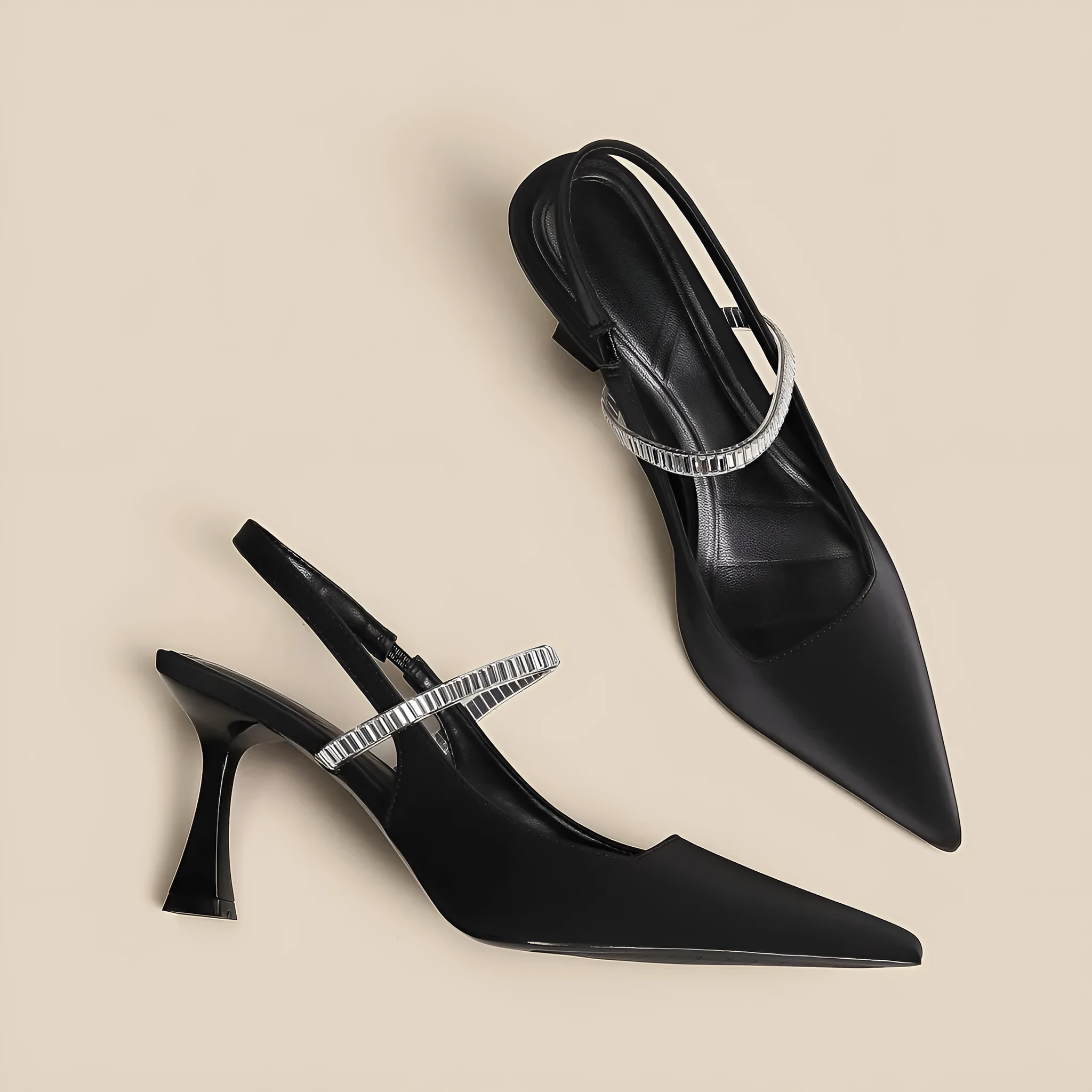 Women's black stiletto heel sandals with a closed toe and a silver buckle strap across the instep.