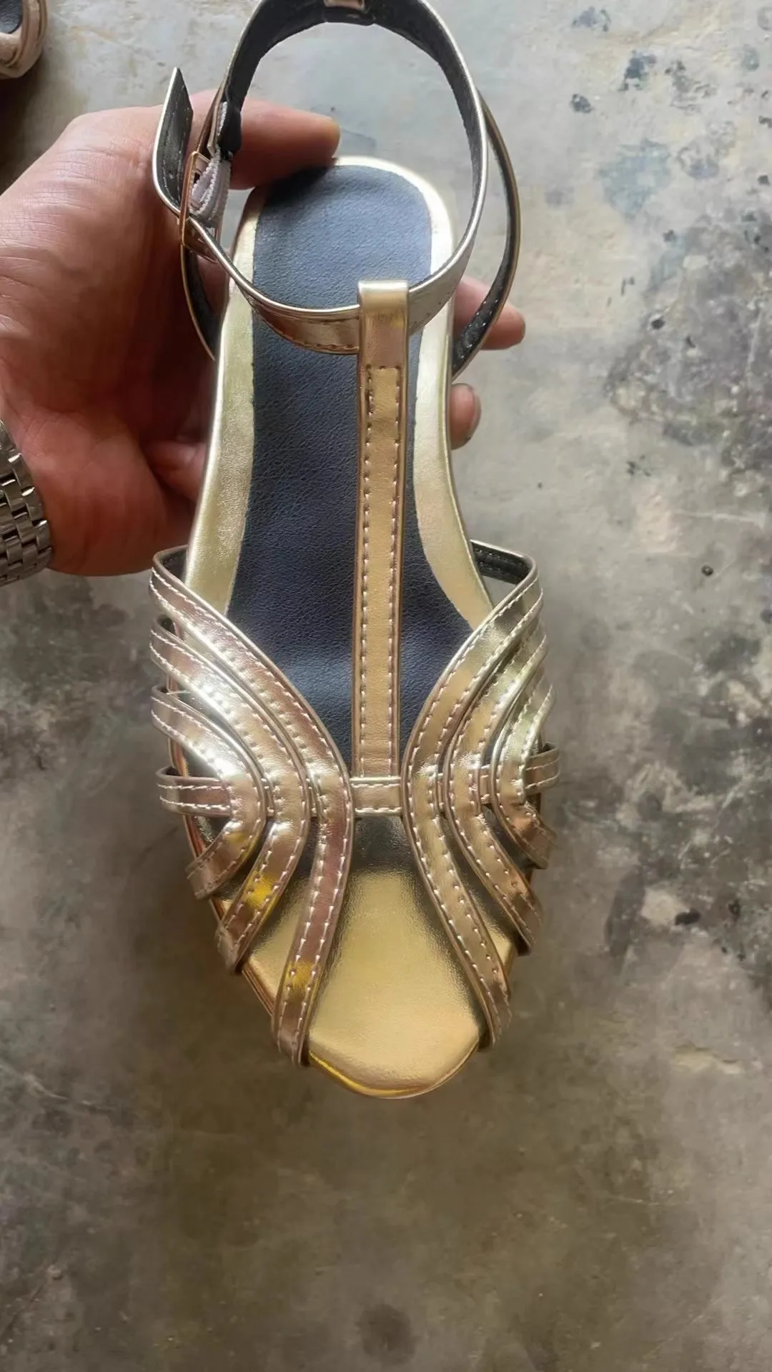 Gold flat peep toe ankle buckle hollow women's sandals with PU upper and rubber sole on a light background