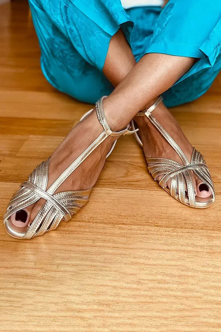 Gold flat peep toe ankle buckle hollow women's sandals with PU upper and rubber sole on a light background