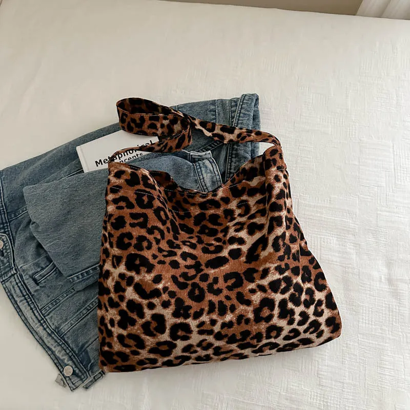 Leopard print shoulder messenger bag with square vertical shape and single strap, available in black, brown, and pink