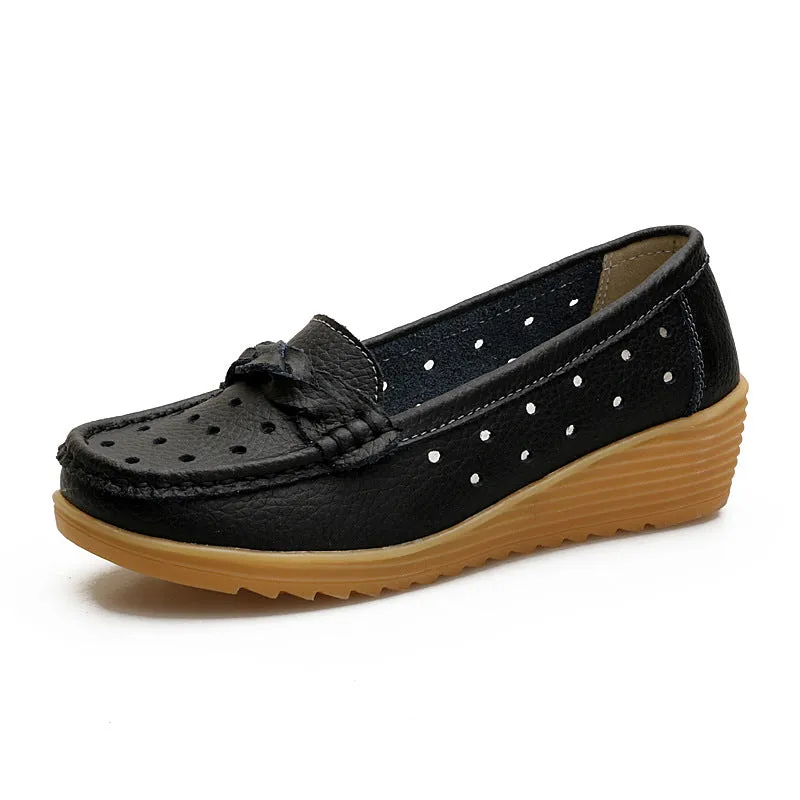 Women's cowhide Gommino soft bottom wedge heels in round toe style with genuine leather upper on display