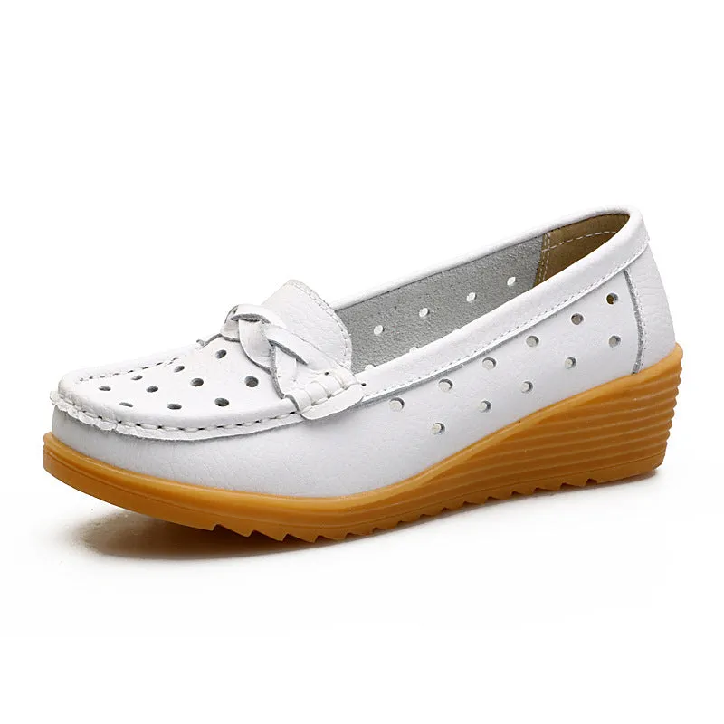 Women's cowhide Gommino soft bottom wedge heels in round toe style with genuine leather upper on display