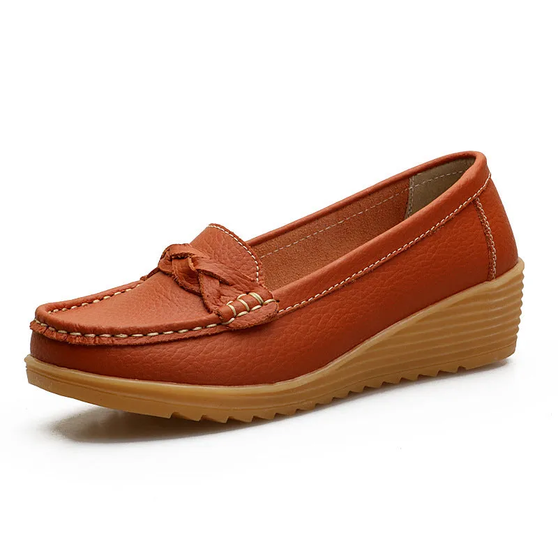 Women's cowhide Gommino soft bottom wedge heels in round toe style with genuine leather upper on display