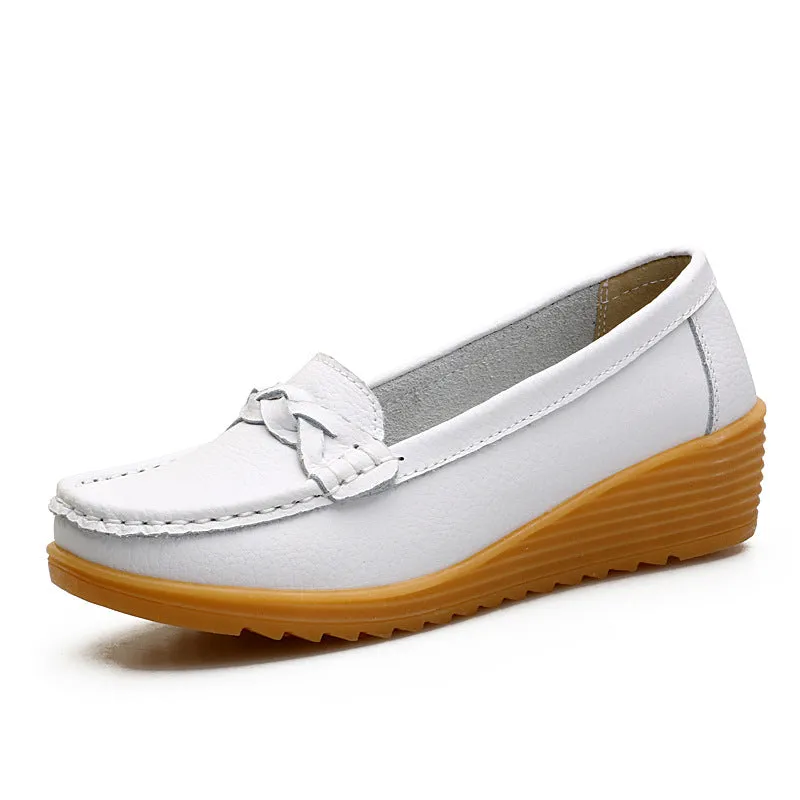 Women's cowhide Gommino soft bottom wedge heels in round toe style with genuine leather upper on display