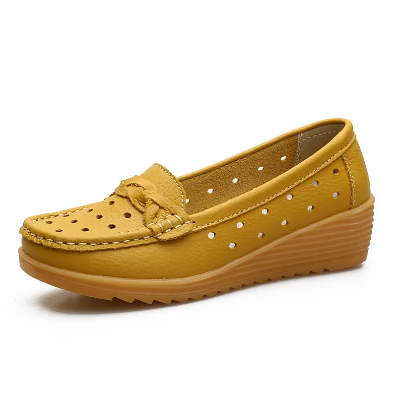 Women's cowhide Gommino soft bottom wedge heels in round toe style with genuine leather upper on display