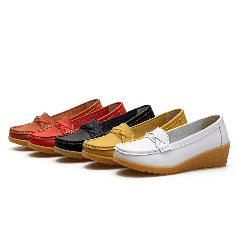 Women's cowhide Gommino soft bottom wedge heels in round toe style with genuine leather upper on display