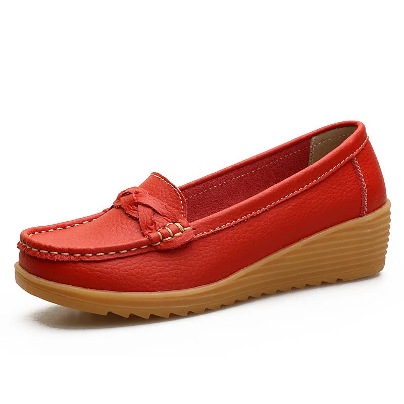 Women's cowhide Gommino soft bottom wedge heels in round toe style with genuine leather upper on display