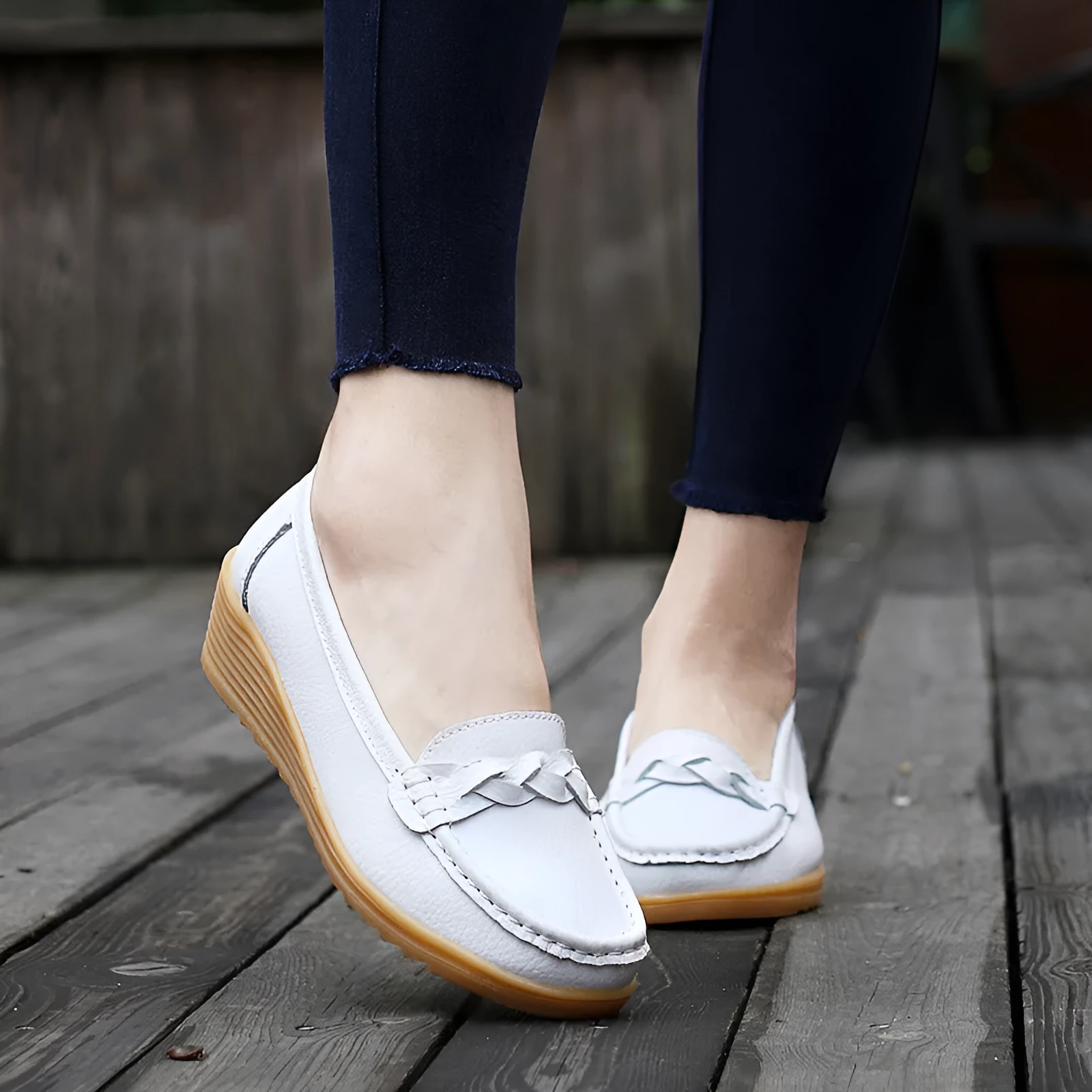 Women's cowhide Gommino soft bottom wedge heels in round toe style with genuine leather upper on display