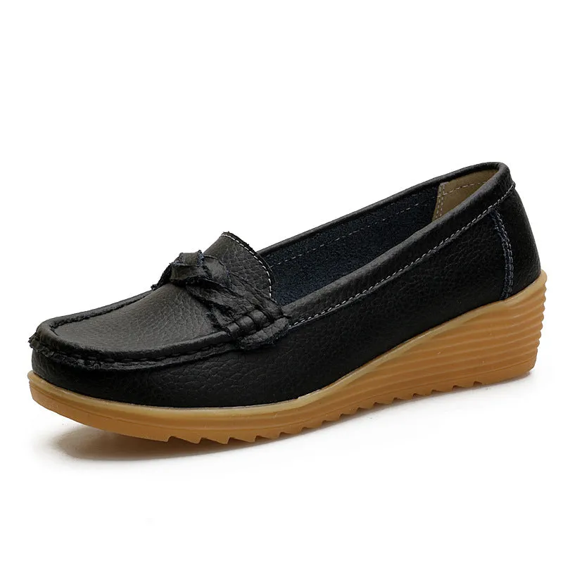Women's cowhide Gommino soft bottom wedge heels in round toe style with genuine leather upper on display