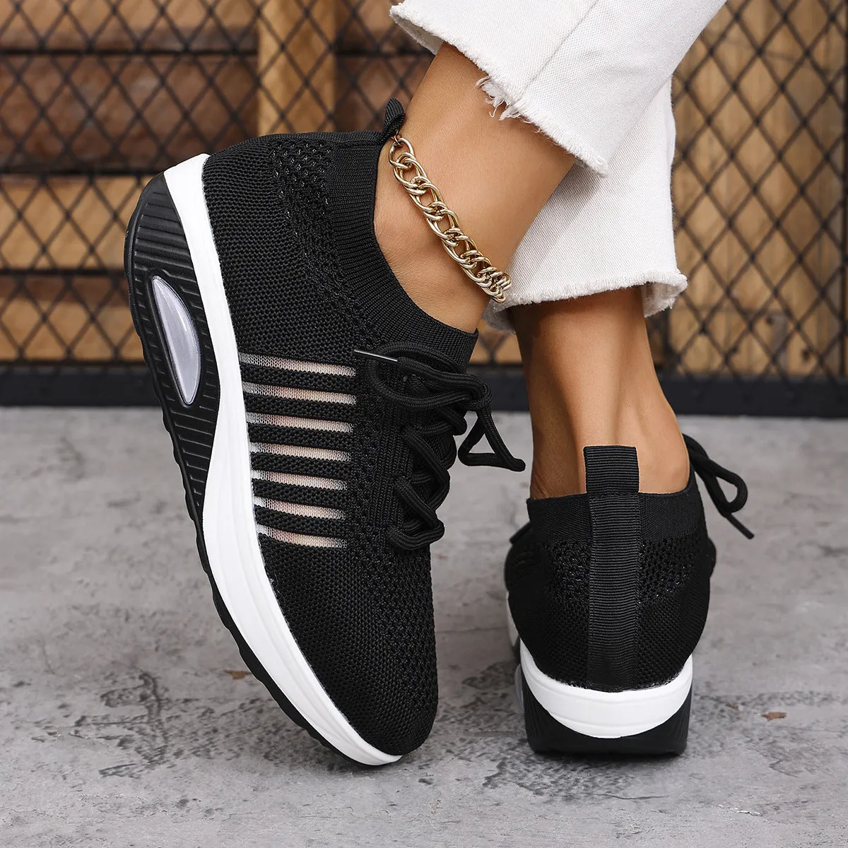 Women's lace-up slip-on wedge sports shoes in black with mesh upper and mid heel height increase
