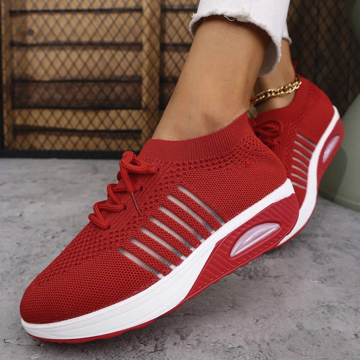 Women's lace-up slip-on wedge sports shoes in black with mesh upper and mid heel height increase
