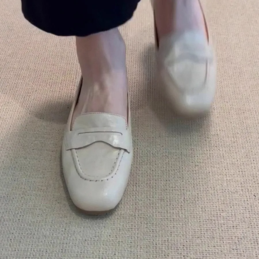 Beige white women's square toe flat shoes with cowhide upper and low heel on a plain background