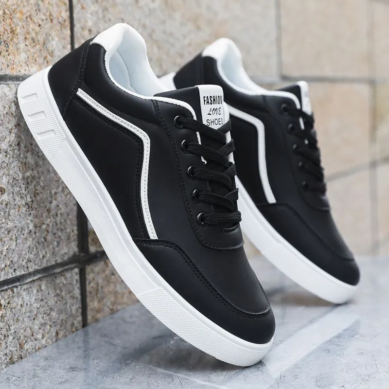 Korean style low top board sneakers in black with white stitching and a flat rubber sole.