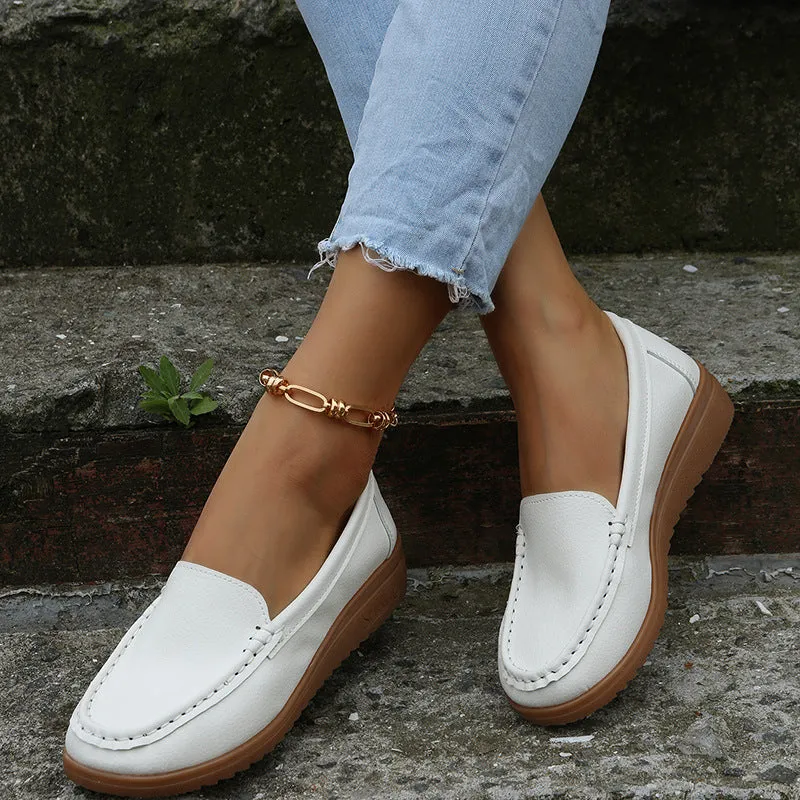 Women's black PU leather slip-on loafers with a round toe and flat rubber sole.