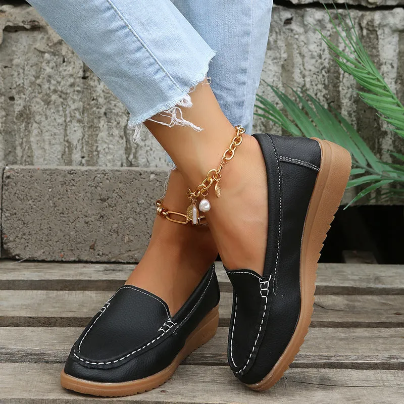 Women's black PU leather slip-on loafers with a round toe and flat rubber sole.