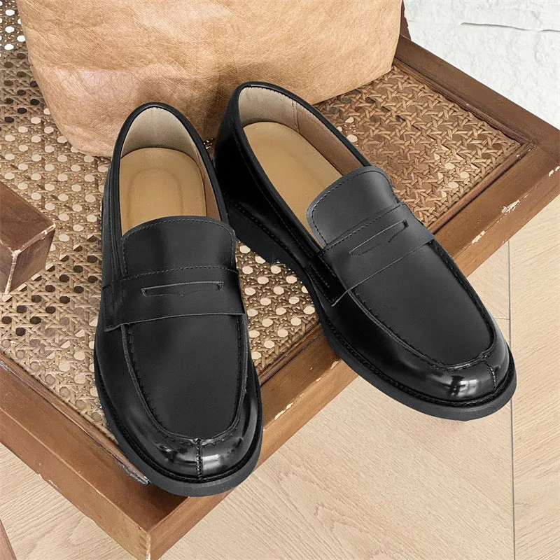 Black men's classic slip-on derby leather shoes with a rubber sole on a white background