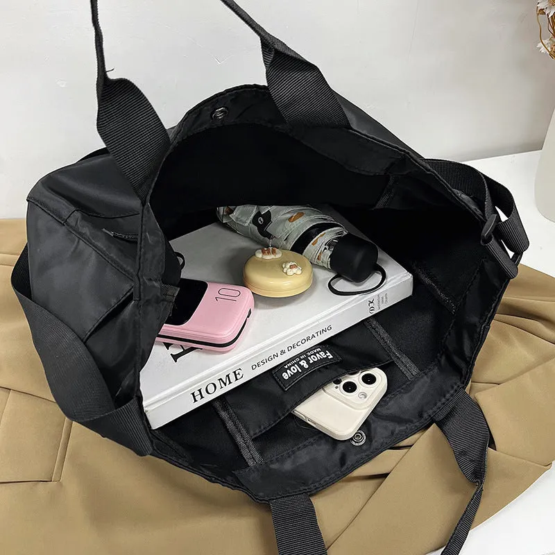 Large capacity nylon crossbody bag for women, black colour, soft material, with three shoulder straps