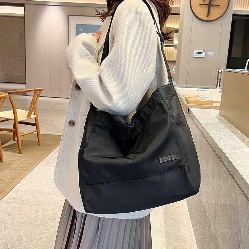 Large capacity nylon crossbody bag for women, black colour, soft material, with three shoulder straps