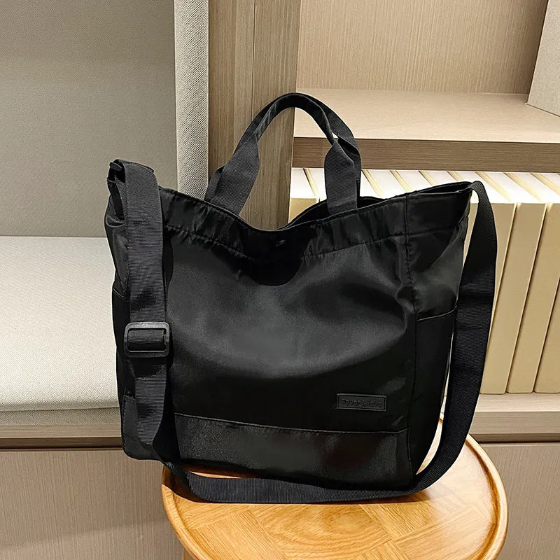 Large capacity nylon crossbody bag for women, black colour, soft material, with three shoulder straps