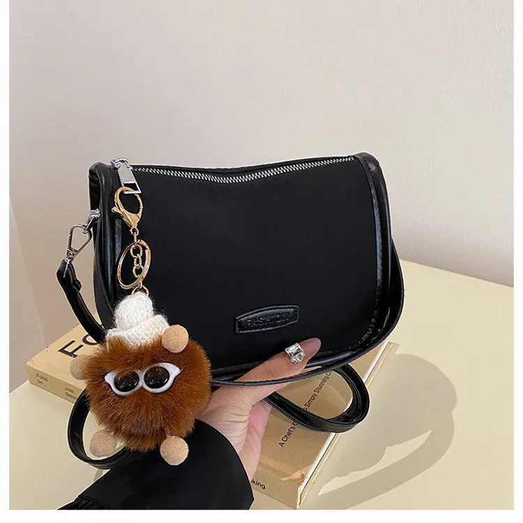 High-textured PU messenger bag with leopard print, horizontal square shape, and decorative pendant