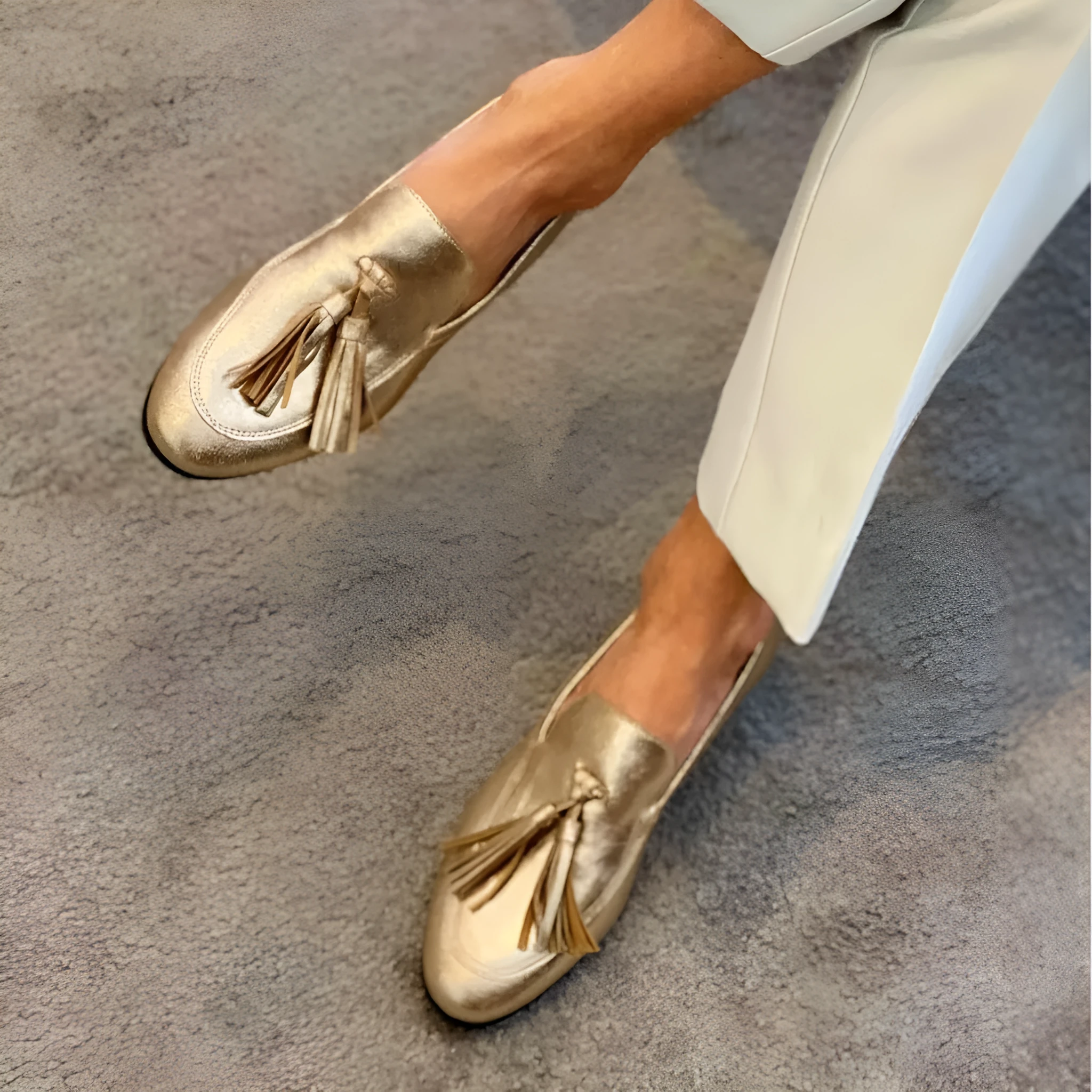 Gold PU leather tassel round toe casual flat loafers with low heel on white background