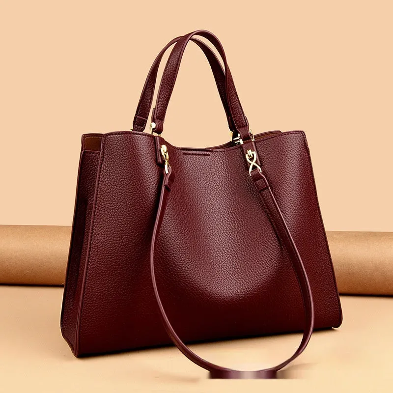 Women's square black PU messenger bag with crossbody strap showing internal organiser pockets.