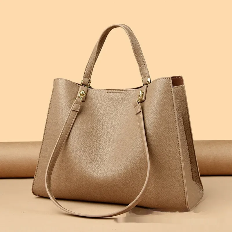 Women's square black PU messenger bag with crossbody strap showing internal organiser pockets.