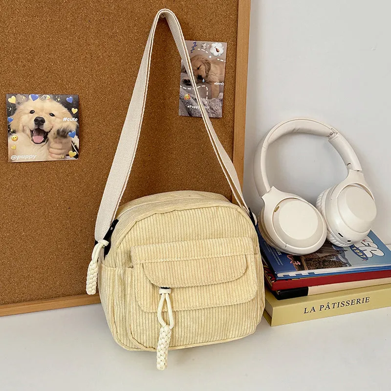Corduroy crossbody shoulder bag in black with ribbon pendant, horizontal square shape