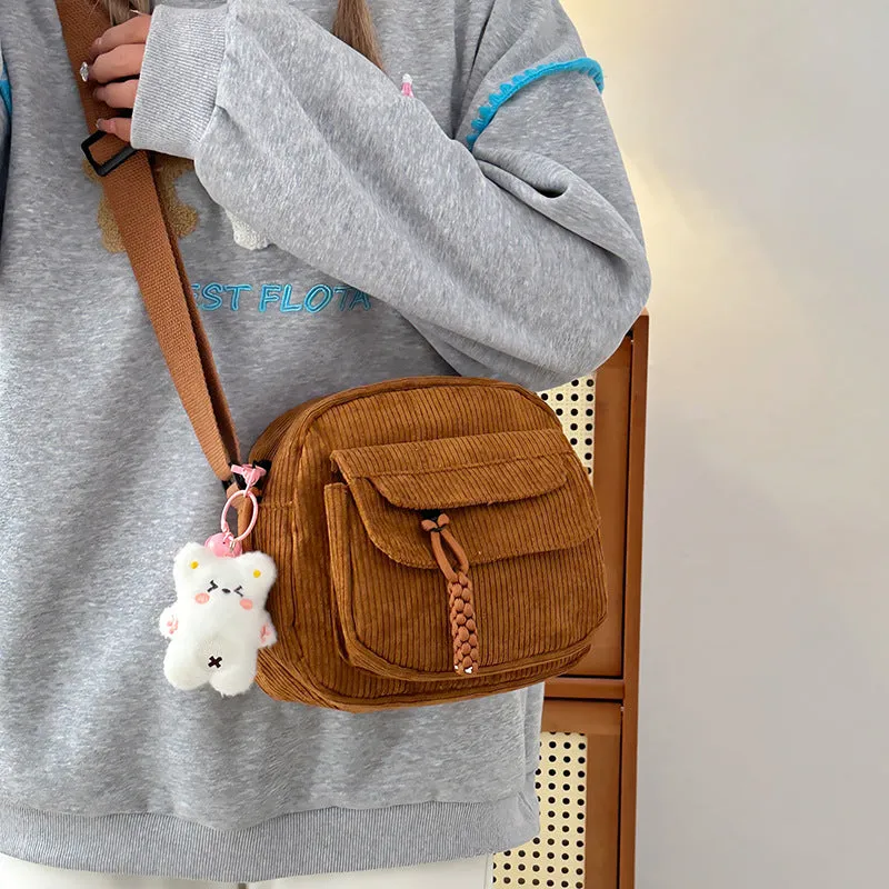 Corduroy crossbody shoulder bag in black with ribbon pendant, horizontal square shape