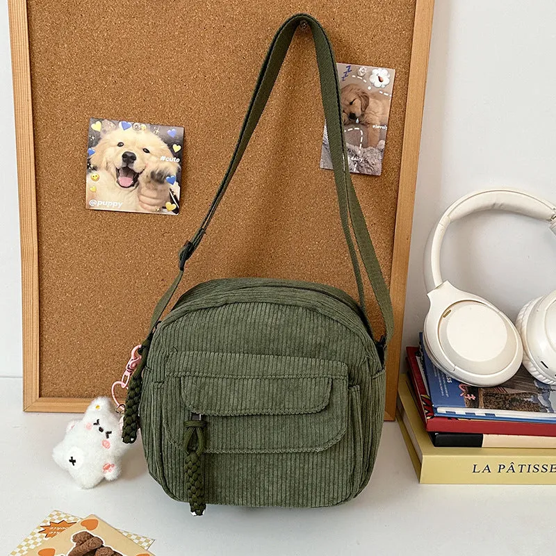 Corduroy crossbody shoulder bag in black with ribbon pendant, horizontal square shape