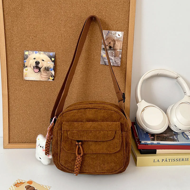 Corduroy crossbody shoulder bag in black with ribbon pendant, horizontal square shape