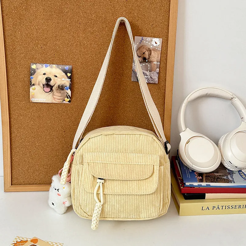 Corduroy crossbody shoulder bag in black with ribbon pendant, horizontal square shape