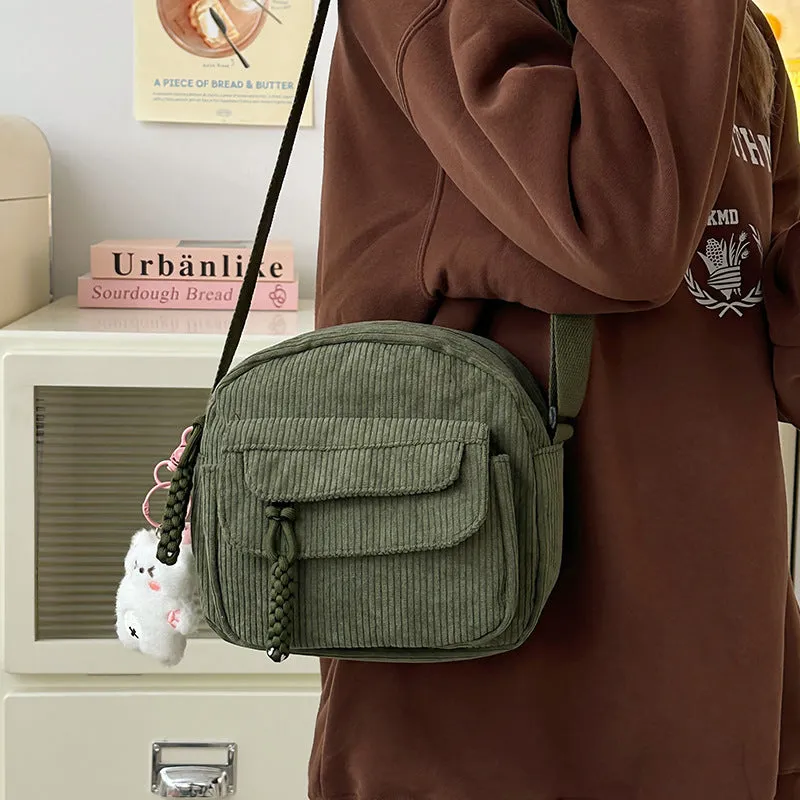 Corduroy crossbody shoulder bag in black with ribbon pendant, horizontal square shape